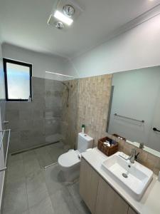 a bathroom with a white toilet and a sink at Carnarvon Castle Eagle Bay in Dunsborough +73 photos