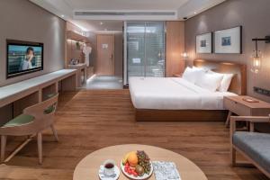 Postel nebo postele na pokoji v ubytování Yunjian Hotel