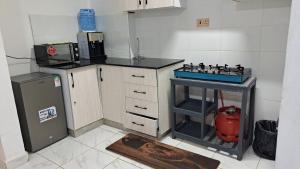 a kitchen with a stove and a refrigerator at Delight stays in Ongata Rongai 
