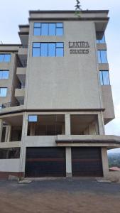 a building with a sign on the side of it at Delight stays in Ongata Rongai 