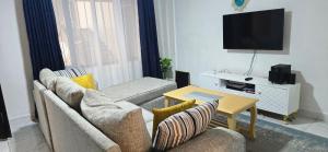a living room with a couch and a table at Delight stays in Ongata Rongai 