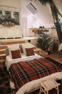 a bedroom with a bed and a christmas tree at Le photo studio in Tremblois-lès-Rocroi