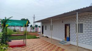 a house with a bench in front of it at Farm House With Swimming pool, Celebration area Below 5000 yadagirigutta Hyderabad in Wasalmari