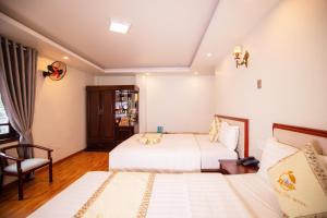 Ένα ή περισσότερα κρεβάτια σε δωμάτιο στο Thanh Do Hotel