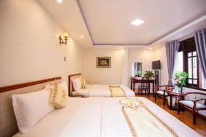 Ένα ή περισσότερα κρεβάτια σε δωμάτιο στο Thanh Do Hotel