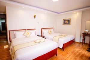 Ένα ή περισσότερα κρεβάτια σε δωμάτιο στο Thanh Do Hotel