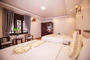 Ένα ή περισσότερα κρεβάτια σε δωμάτιο στο Thanh Do Hotel