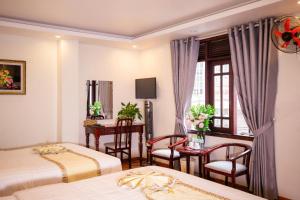 Ένα ή περισσότερα κρεβάτια σε δωμάτιο στο Thanh Do Hotel