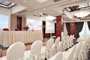 a conference room with white chairs and a table at Mediterranean Hotel in Rhodes Town