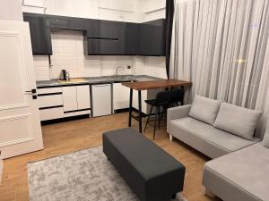 a kitchen and living room with a couch and a table at Başaran Rezidans & Otel in Malatya