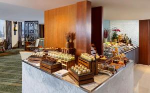 a buffet in a hotel lobby with food on display at Mandarin Oriental, Jakarta in Jakarta