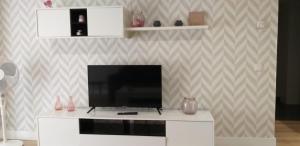 a living room with a flat screen tv on a white cabinet at Apartamentos Nájera in Nájera