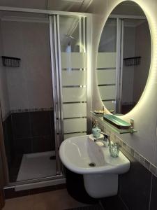 a bathroom with a sink and a mirror and a shower at Ático Pola in Santa Pola +18 photos