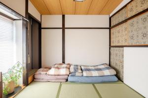 a room with two pillows sitting on the floor at Y's INN Ikebukuro 013T in Tokyo