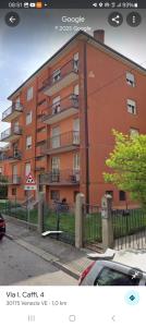 a red building with a car parked in front of it at Easy Old City Apt Venice in Venice