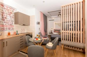 a kitchen and a living room with a table and chairs at Lovebirds Luxury Apartment in Rethymno Town +27 photos