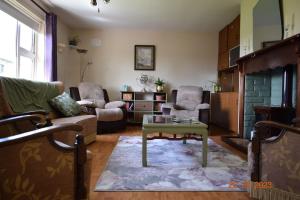 a living room with a couch and a table at Hillgrove, Borrisokane in Goatstown