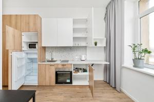 a kitchen with white cabinets and a counter top at Air Apartments - Code entry only, No staff in Vilnius +28 photos