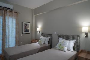 A bed or beds in a room at Absolute Athens Apartments