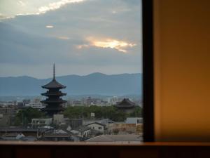 a view of a city from a window at Loisir Hotel Kyoto Toji in Kyoto