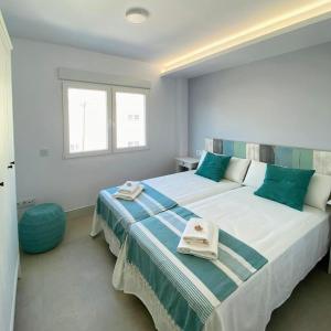 a bedroom with a large bed with towels on it at MAR y CALMA NG in Benicarló