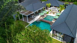 an aerial view of a house with a swimming pool at Villa Cocktail and Dreams by BaliSuperHost in Ubud