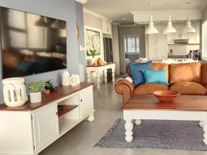 a living room with a couch and a table at Frinton on Sea 12 in Ballito