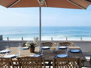 a dining table with a view of the ocean at Frinton on Sea 12 in Ballito