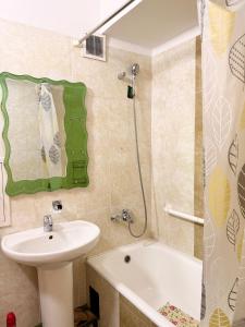 a bathroom with a sink and a toilet and a tub at Ub Friends Guest House in Ulaanbaatar +4 photos