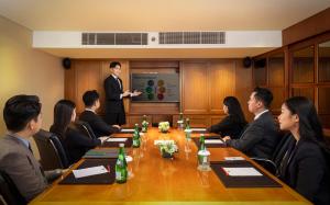 a group of people sitting around a table in a room at Mandarin Oriental, Jakarta in Jakarta