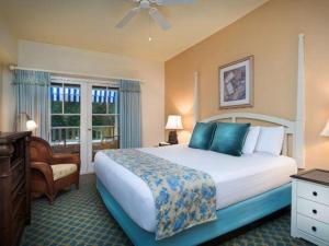 a hotel room with a large bed and a chair at Disney's Boardwalk Inn in Orlando +85 photos