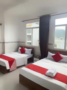 a bedroom with two beds and a window at LUXURY Motel in Da Nang