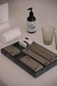 a bathroom counter with some soap and a sink at Shenzhen INNOGYM Hotel in Shenzhen