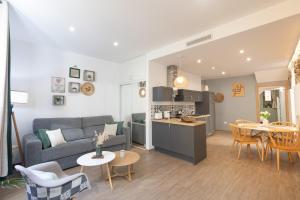 a living room and kitchen with a couch and a table at Le Mattoni 2 in Menton