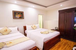 Ένα ή περισσότερα κρεβάτια σε δωμάτιο στο Thanh Do Hotel