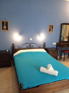 a bedroom with a bed with a towel on it at Kouvaras Apartments in Kythira