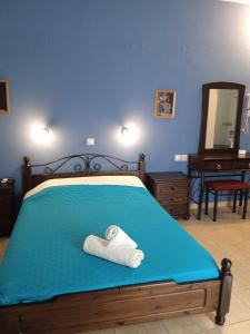 a bedroom with a bed with a towel on it at Kouvaras Apartments in Kýthira