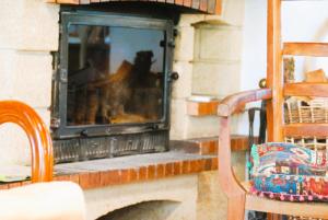 a fireplace with a dog sitting in the window at Grande maison escapade au bord de la riviere in Touvre +58 photos