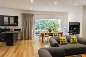 a living room and kitchen with a couch and a table at Cherry Blossom Boutique Stay, Ceres in Ceres