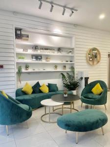 a living room with a couch and chairs and a table at ATAP Hotel in Kota Kinabalu
