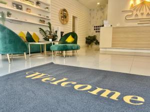 a welcome rug in a lobby with chairs and a table at ATAP Hotel in Kota Kinabalu