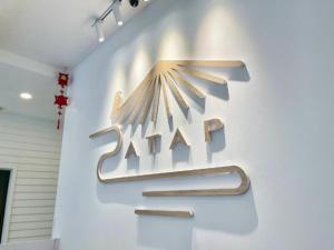 a sign for a zaha sign on a wall at ATAP Hotel in Kota Kinabalu