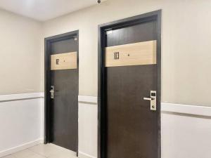 two wooden doors in a room with at ATAP Hotel in Kota Kinabalu