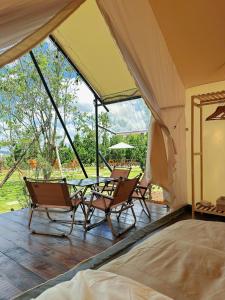 a tent with chairs and a table in it at Santolina Homestay - Tây Hồ Hill in Da Lat