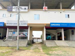 a building with a street sign in front of it at Kanchan Homestay in Nowgong +9 photos