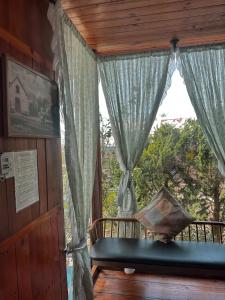 a room with a window with curtains and a bench at Santolina Homestay - Tây Hồ Hill in Da Lat +103 photos