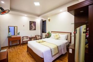Ένα ή περισσότερα κρεβάτια σε δωμάτιο στο Thanh Do Hotel