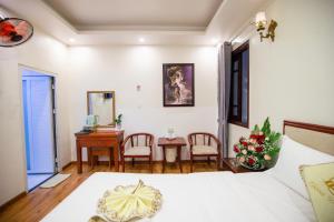 Ένα ή περισσότερα κρεβάτια σε δωμάτιο στο Thanh Do Hotel