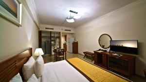 a hotel room with a bed and a mirror at Rose Garden Hotel Apartments - Bur Dubai in Dubai