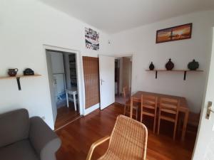 a living room with a couch and a table and chairs at Retro Kuckó in Balatonfenyves +2 photos